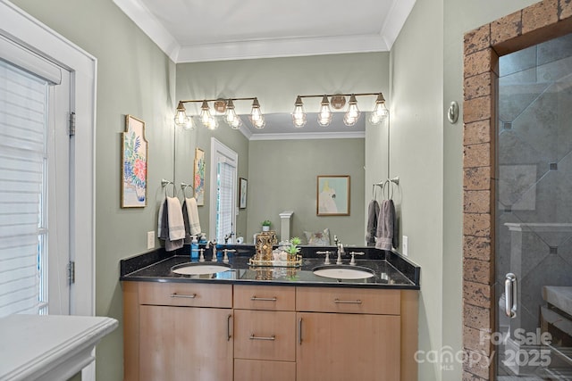 bathroom featuring crown molding, a stall shower, and a sink