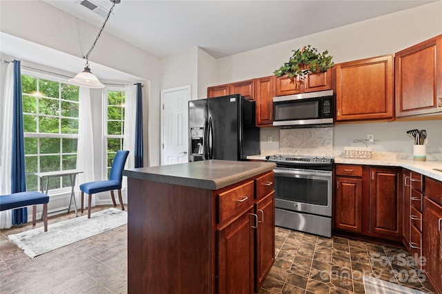 12905 Bullock Greenway Blvd, Charlotte, NC 28277 - kitchen with tasteful backsplash, a center island, decorative light fixtures, appliances with stainless steel finishes, and stone finish floor