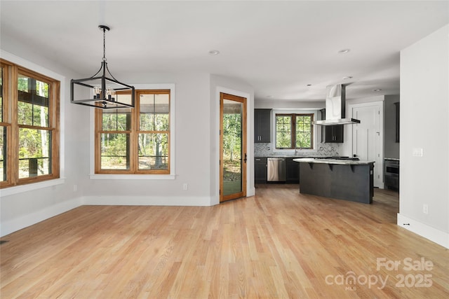29 Wild Deer Trl, Zirconia, NC 28790 - kitchen featuring exhaust hood, stainless steel dishwasher, a chandelier, light countertops, and a breakfast bar area