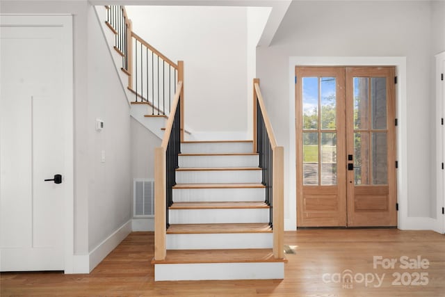 29 Wild Deer Trl, Zirconia, NC 28790 - entryway with wood finished floors, stairway, and french doors