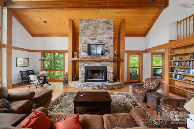 29 Wild Deer Trl, Zirconia, NC 28790 - living area with high vaulted ceiling, wooden ceiling, plenty of natural light, wood finished floors, and a stone fireplace