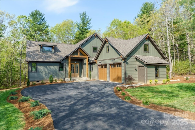 29 Wild Deer Trl, Zirconia, NC 28790 - view of front of home with driveway, roof with shingles, a front yard, french doors, and board and batten siding