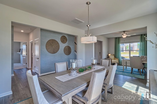 dining room with visible vents, baseboards, ceiling fan, and wood finished floors
