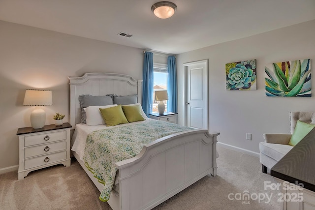 bedroom featuring baseboards, visible vents, and light colored carpet