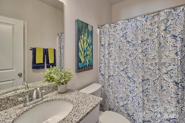 bathroom featuring a shower with curtain, toilet, and vanity