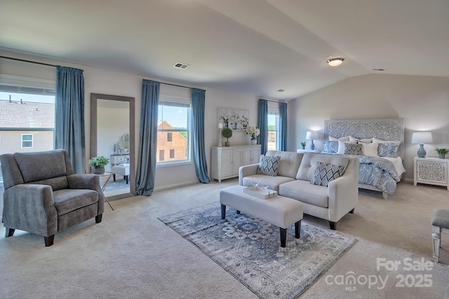 bedroom featuring light carpet, baseboards, vaulted ceiling, and visible vents