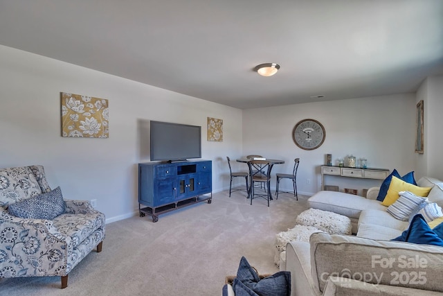 living area with light colored carpet and baseboards