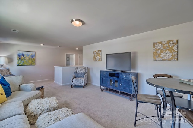 carpeted living room featuring baseboards and visible vents