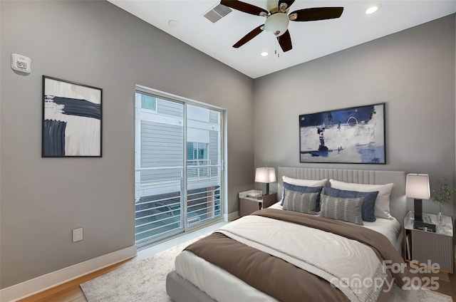 bedroom with visible vents, baseboards, a ceiling fan, wood finished floors, and access to outside