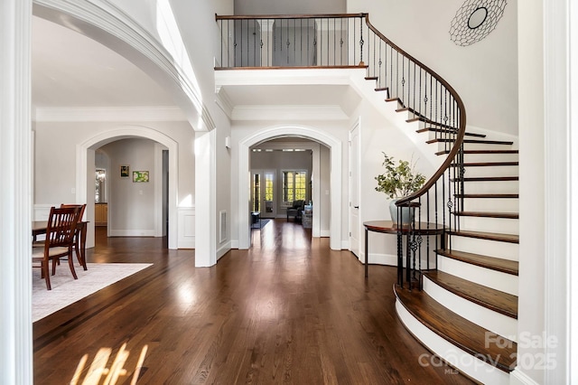 1404 Churchill Downs Dr, Waxhaw, NC 28173 - entryway featuring a high ceiling, arched walkways, dark wood finished floors, visible vents, and ornamental molding