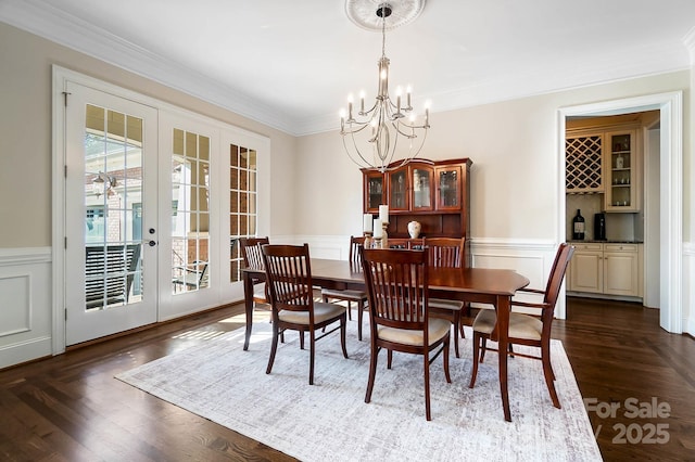 1404 Churchill Downs Dr, Waxhaw, NC 28173 - dining space with crown molding, a wainscoted wall, french doors, and a chandelier