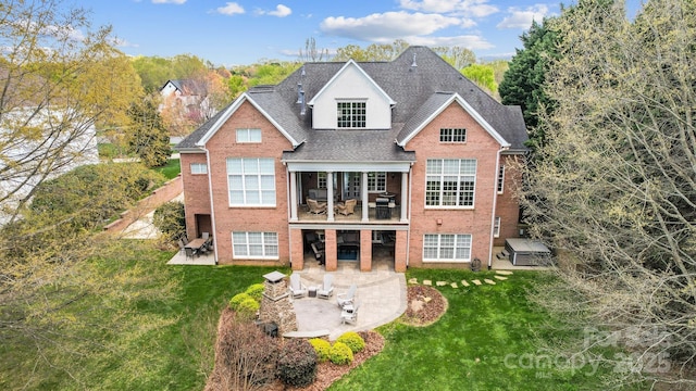1404 Churchill Downs Dr, Waxhaw, NC 28173 - back of property featuring a patio, a shingled roof, a lawn, and brick siding