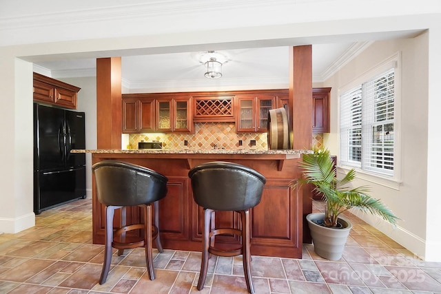 1404 Churchill Downs Dr, Waxhaw, NC 28173 - bar with baseboards, decorative backsplash, freestanding refrigerator, and ornamental molding