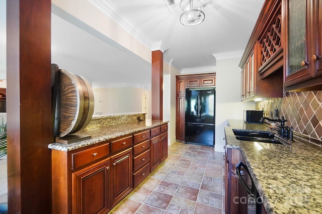 1404 Churchill Downs Dr, Waxhaw, NC 28173 - kitchen featuring decorative backsplash, dark brown cabinets, a sink, stone countertops, and freestanding refrigerator