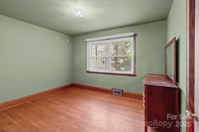 unfurnished bedroom with visible vents, baseboards, and light wood-style floors