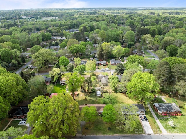 drone / aerial view featuring a forest view