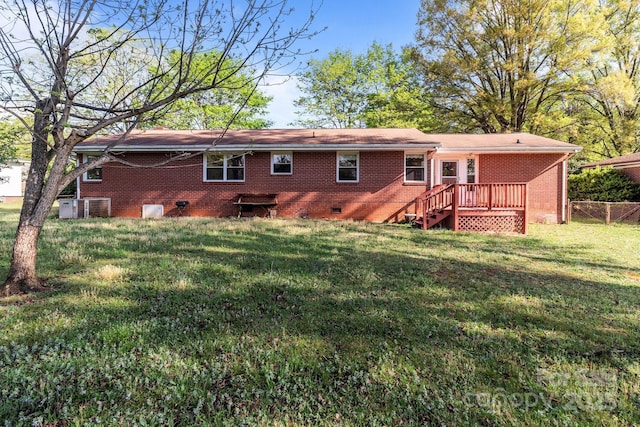 rear view of property with crawl space, central air condition unit, a yard, fence, and brick siding