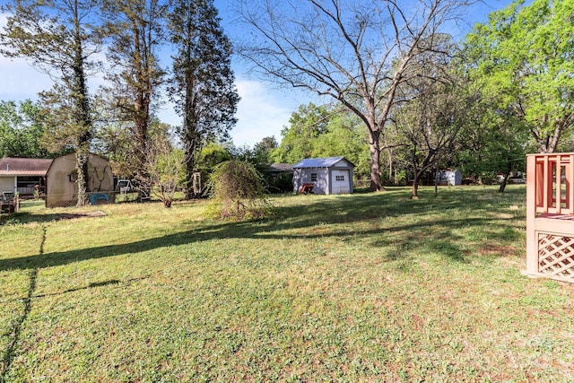 view of yard featuring an outbuilding and a shed