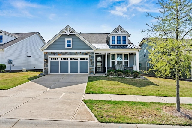 8718 Festival Way, Charlotte, NC 28215 - craftsman inspired home with covered porch, metal roof, a front yard, stone siding, and concrete driveway