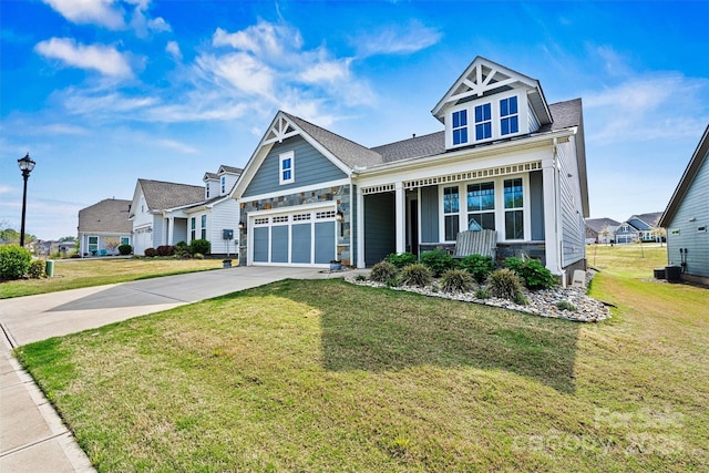 8718 Festival Way, Charlotte, NC 28215 - craftsman house with concrete driveway, stone siding, a front yard, a porch, and central AC