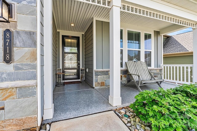 8718 Festival Way, Charlotte, NC 28215 - entrance to property with board and batten siding, a porch, and stone siding