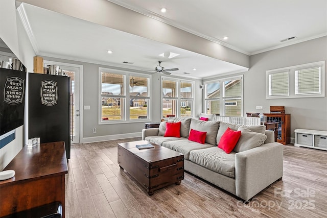 8718 Festival Way, Charlotte, NC 28215 - living room with ornamental molding, visible vents, ceiling fan, and light wood-type flooring