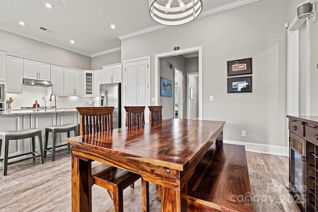 8718 Festival Way, Charlotte, NC 28215 - dining room with crown molding, visible vents, recessed lighting, light wood finished floors, and baseboards