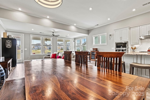 8718 Festival Way, Charlotte, NC 28215 - dining room featuring a healthy amount of sunlight, ornamental molding, and visible vents