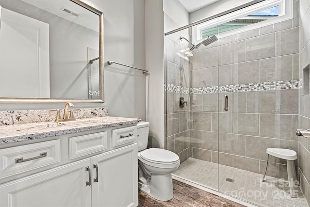 8718 Festival Way, Charlotte, NC 28215 - bathroom featuring visible vents, toilet, a stall shower, and vanity