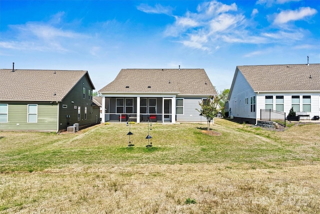 8718 Festival Way, Charlotte, NC 28215 - back of house featuring central AC, a sunroom, and a lawn
