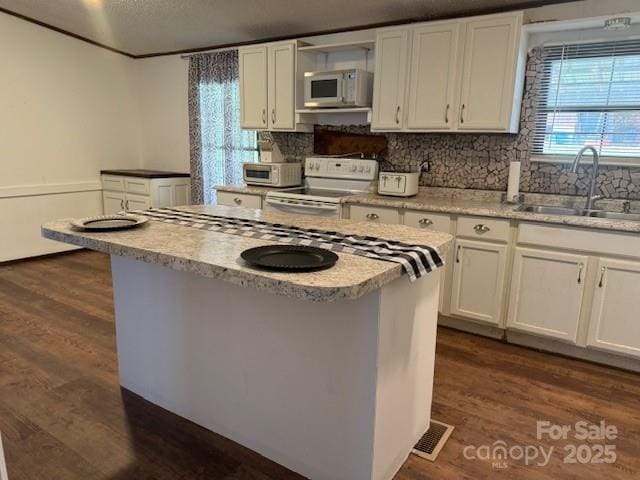 5061 Windy Woods Rd, Morganton, NC 28655 - kitchen with visible vents, white cabinetry, a sink, and white appliances