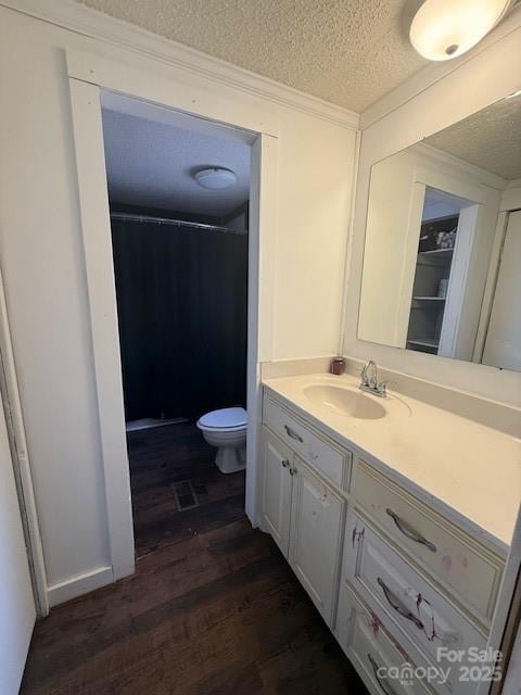 5061 Windy Woods Rd, Morganton, NC 28655 - full bath with a textured ceiling, toilet, wood finished floors, vanity, and a shower with curtain