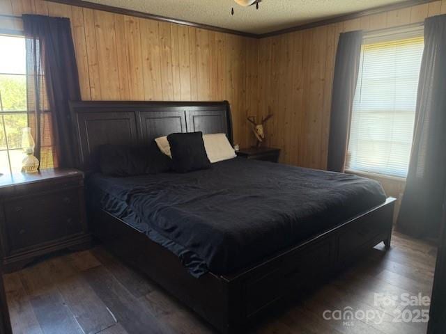 5061 Windy Woods Rd, Morganton, NC 28655 - bedroom with wooden walls, ornamental molding, dark wood-type flooring, and a textured ceiling
