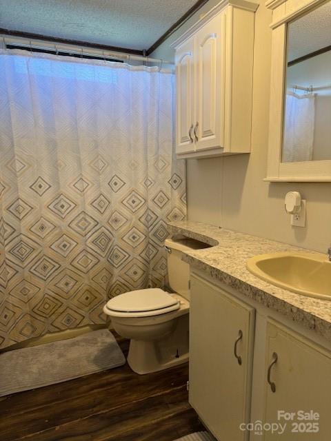 5061 Windy Woods Rd, Morganton, NC 28655 - bathroom featuring a textured ceiling, a shower with shower curtain, wood finished floors, toilet, and vanity
