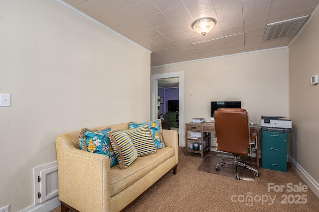 carpeted office space with crown molding, baseboards, and visible vents