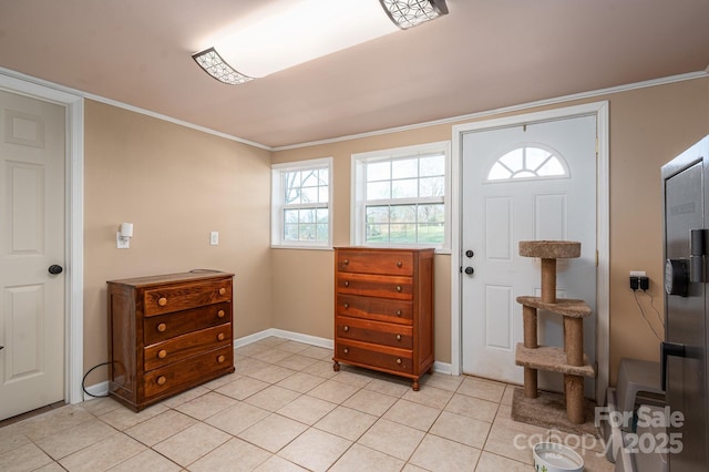 foyer entrance featuring crown molding, light tile patterned floors, and baseboards