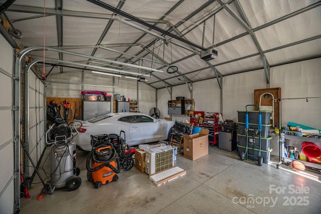 garage with a garage door opener and metal wall