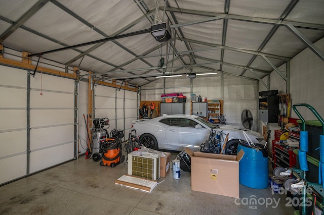 garage featuring metal wall and a garage door opener
