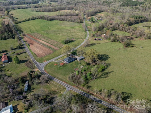 birds eye view of property with a rural view