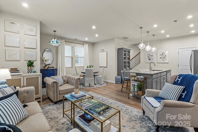 1354 Galloway Rd, Charlotte, NC 28262 - living room featuring visible vents, baseboards, light wood finished floors, and recessed lighting