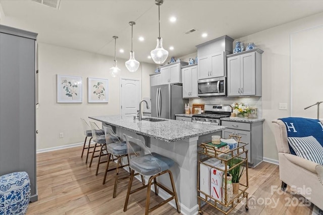 1354 Galloway Rd, Charlotte, NC 28262 - kitchen with visible vents, gray cabinets, a sink, stainless steel appliances, and backsplash