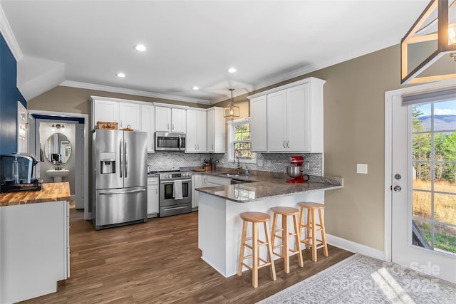 1294 Saylor Way, Nebo, NC 28761 - kitchen with a peninsula, appliances with stainless steel finishes, a sink, wood counters, and decorative backsplash