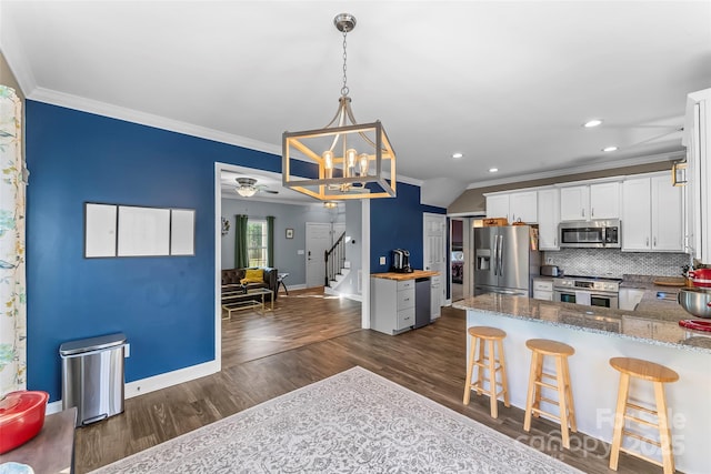 1294 Saylor Way, Nebo, NC 28761 - kitchen with an inviting chandelier, dark wood-style flooring, crown molding, stainless steel appliances, and backsplash