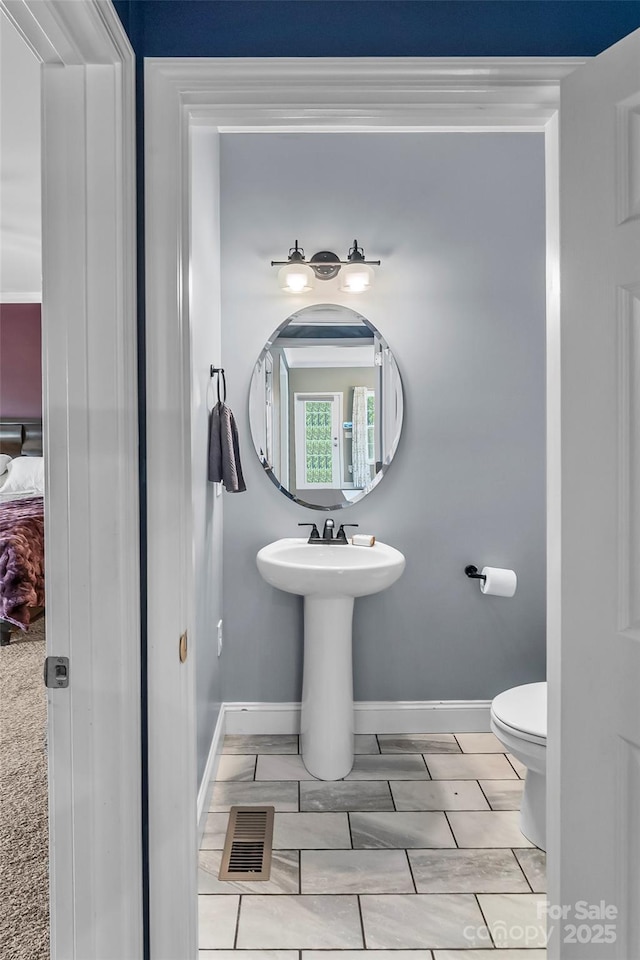 1294 Saylor Way, Nebo, NC 28761 - bathroom featuring a sink, visible vents, toilet, and baseboards