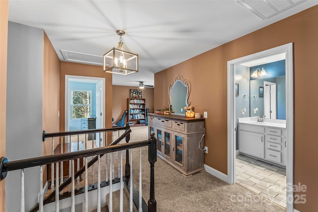 1294 Saylor Way, Nebo, NC 28761 - hall with light colored carpet, visible vents, a sink, an upstairs landing, and baseboards
