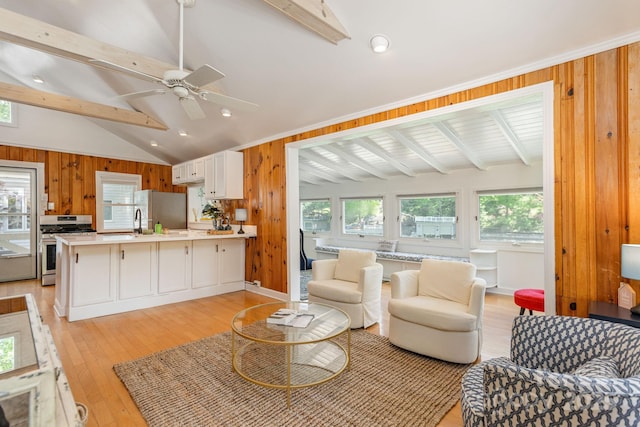 386 Charlotte Dr, Lake Lure, NC 28746 - living room with wooden walls, vaulted ceiling with beams, light wood-type flooring, and a wealth of natural light
