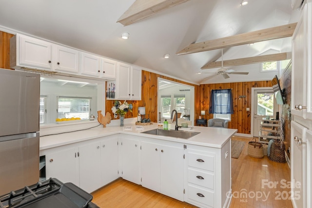 386 Charlotte Dr, Lake Lure, NC 28746 - kitchen with a sink, freestanding refrigerator, light wood-type flooring, and a peninsula