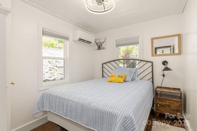 386 Charlotte Dr, Lake Lure, NC 28746 - bedroom featuring baseboards, multiple windows, a wall unit AC, and wood finished floors