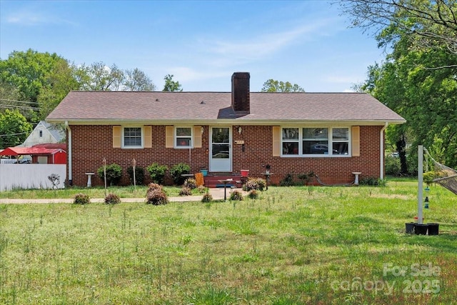 ranch-style house with a chimney and brick siding