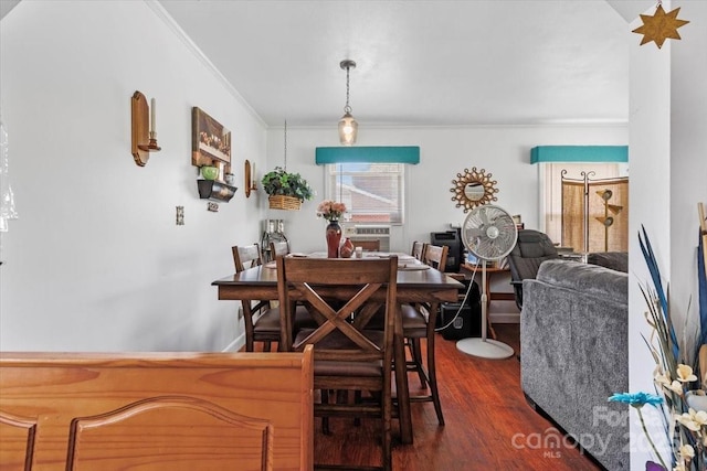 dining room featuring crown molding and dark wood-style floors